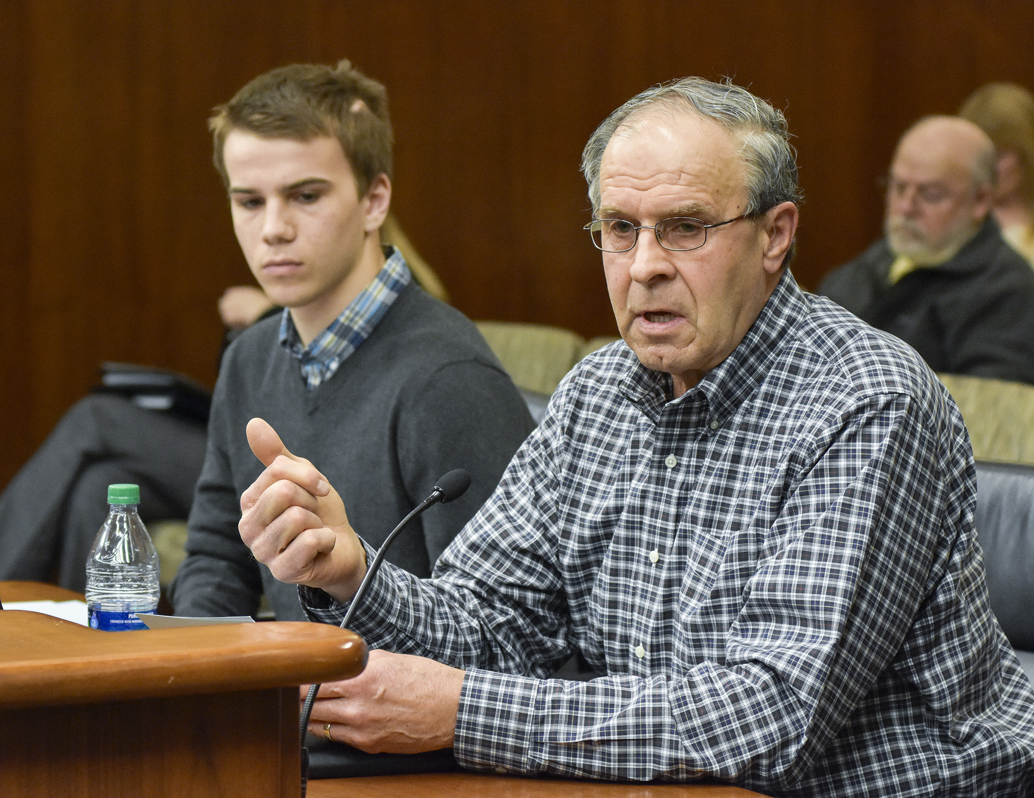 Pat O’Boyle, right, and his grandson, Max Rabidue, testify before the House Mining and Outdoor Recreation Policy Committee March 16 on HF3209, a bill that would prohibit adoption of rules limiting use of lead shot. Photo by Andrew VonBank
